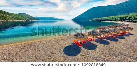 Foto stock: Beach Umbrellas And Loungers At Greek Sea