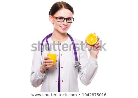 Stockfoto: Female Nutritionist Hold Orange In Section And Glass Of Fresh Juice In Her Hands On White Background