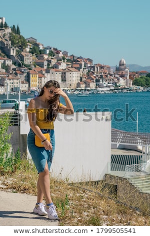 ストックフォト: Happy Woman By Posing Near The Sea In A Hot Summer Day