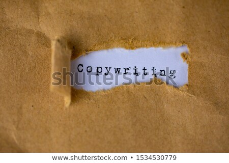 Imagine de stoc: Copyright Text Appearing Behind Torn Brown Paper