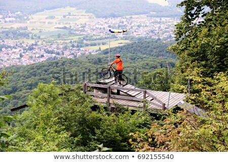 [[stock_photo]]: Mountain Biker Flying Off In Forest