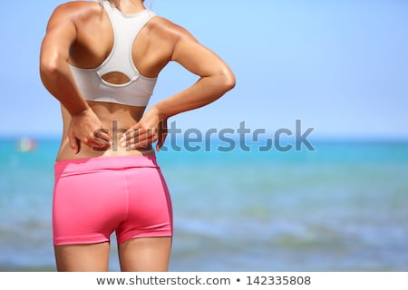 Stockfoto: Young Woman Standing With Back Pain