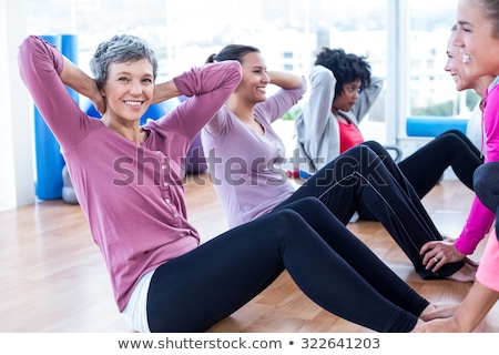 Stock photo: Portrait Of Woman In Sportswear Sitting On Hardwood Floor