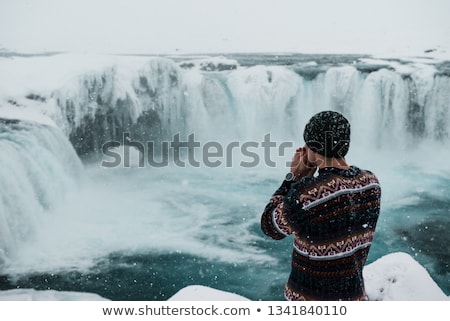 Stok fotoğraf: Man In Icelandic Sweater By Waterfall On Iceland