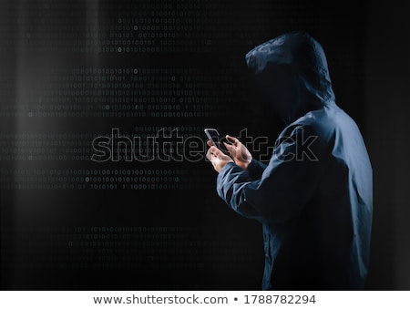 Zdjęcia stock: Hacker With Smartphone And Computers In Dark Room