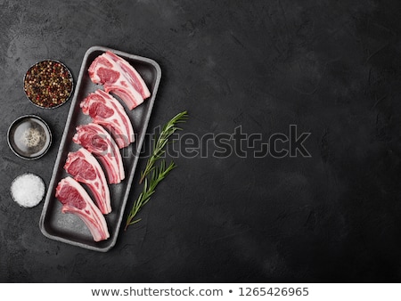 Сток-фото: Fresh Raw Butchers Lamb Beef Cutlets In Plastic Tray With Vintage Meat Hatchets On Black Background