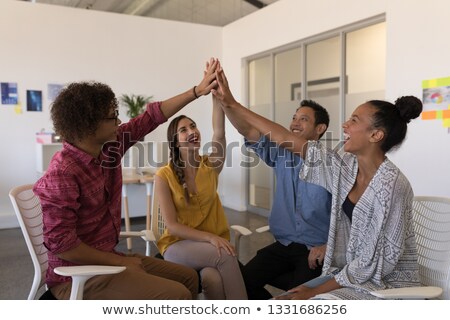 Stockfoto: Front View Of Happy Diverse Business Colleagues Giving High Five To Each Other After Successful Meet