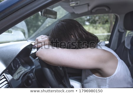 Stok fotoğraf: Young Female Driver At The Wheel Of Her Car Super Tired