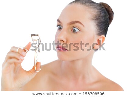 Сток-фото: Surprised Young Woman Holding Eyelash Curler