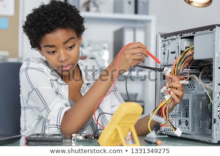 Foto stock: Woman Repairing The Computer