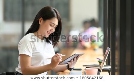 Stockfoto: Woman With Tablet Pc And Stylus In Cafe