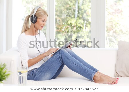 Stock photo: Woman Listening To Music In Her Living