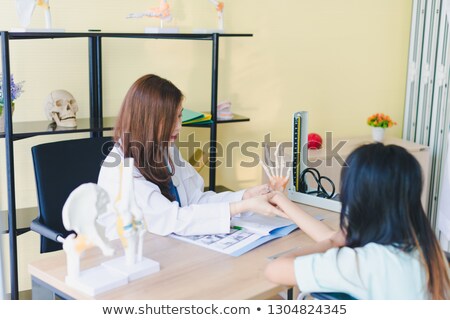 Stock fotó: Physiotherapist Examining Hand Of A Female Patient