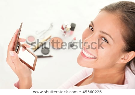 Portrait Of Young Woman Putting On Make Up Stockfoto © Ariwasabi