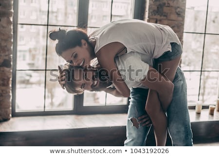 Сток-фото: Cheerful Handsome Man Carrying His Girlfriend Piggyback