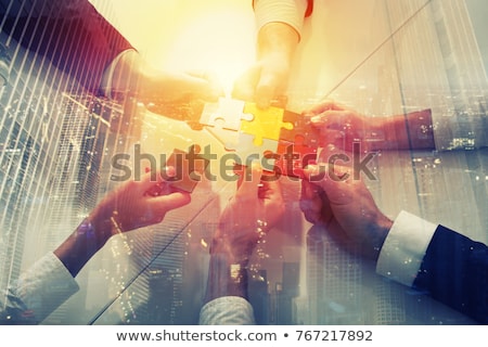 Stok fotoğraf: Teamwork Of Partners Concept Of Integration And Startup With Puzzle Pieces