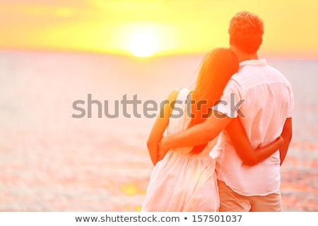 Stock foto: Beautiful Newlyweds Walking Holding Hands At Sunset