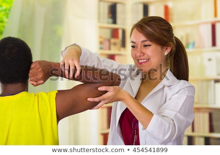 Stok fotoğraf: Physical Therapist Working On Knee Of Woman