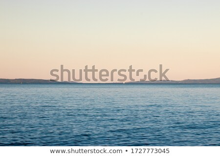Сток-фото: Blue Sea And Sky With Distant Mountains In The Background