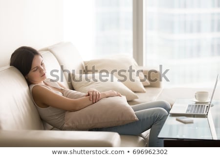 Foto d'archivio: Girl Sleeping On A Couch In Half Light