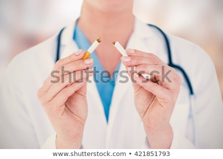Stock photo: Doctor Holding Broken Cigarette