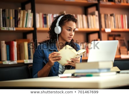 Foto stock: Female Student Studying In Library