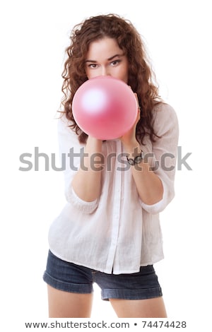 Foto d'archivio: Girl Blowing Inflating Colored Balloons