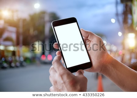 Stock photo: Businessman Texting With Mobile Phone On The Street At Night