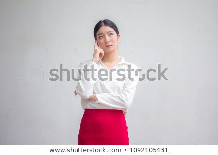 Сток-фото: Portrait Of A Smiling Asian Businesswoman Thinking