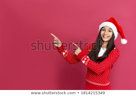 Foto stock: Smiling Girl In Santa Hat With Christmas Gift