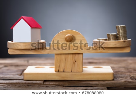 Сток-фото: Model Home And Coins Balancing On Wooden Weighing Scale