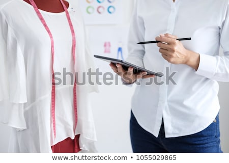 Stockfoto: Stylish Fashion Designer Working With Measure Red Dummy As Sketc