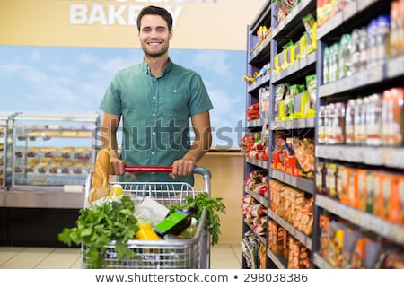 Stock fotó: Man Shopping In Supermarket Pushing His Trolley With Vegetables