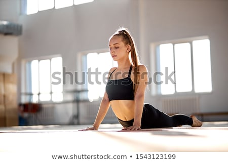 Foto stock: Attractive Acrobat Woman Stretching Legs