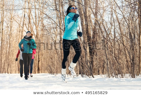 Zdjęcia stock: Group Of Friends Enjoying Jogging In The Snow In Winter