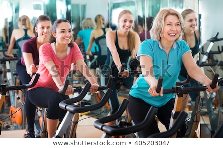 Stock photo: Senior Woman On An Exercise Bike In The Gym