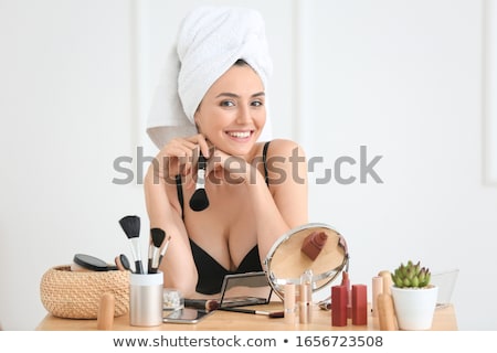 Stockfoto: Beautiful Young Woman Applying Makeup