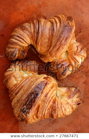 Dwa Ciastka Croissant Na Pomarańczowej Glince Zdjęcia stock © lunamarina