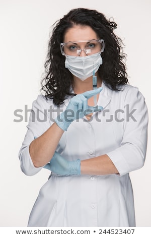 Foto stock: Portrait Of Lady Surgeon Showing Syringe Over White Background