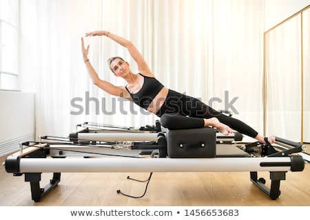 Stock photo: Pilates Reformer Woman Mermaid Exercise