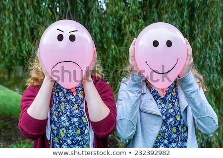 Foto d'archivio: Two Girls Holding Pink Balloons With Facial Expressions For Head