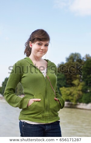 Stock foto: Young Girl Listening To Ipod Near River