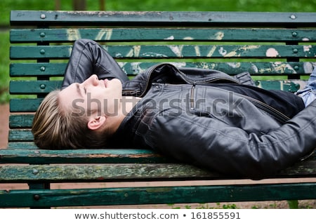 Stock photo: Portrait Of Attractive Young Man In Leather Jacket Looking Down