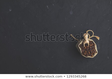 Foto stock: Purse With Roasted Beans And Wooden Scoop On Black Stone Concret