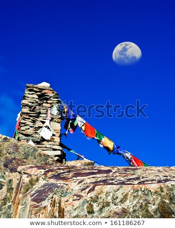 [[stock_photo]]: Highland Road Pass With Stone Pyramid And Buddhist Praying Flags