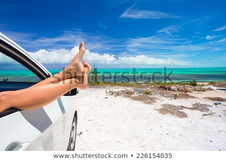 Stock photo: Woman Legs By Blue Sea Background In Car