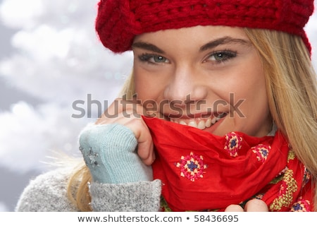 Stok fotoğraf: Teenage Girl Wearing Warm Winter Clothes And Hat In Studio