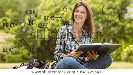 Stock fotó: Female Student Holding Book With Formulas In Foreground