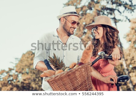 Stockfoto: Couple In On Bike With Picnic Basket