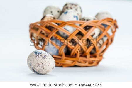 Foto stock: Basket Of White Dotted Easter Eggs In Brown Wicker Basket